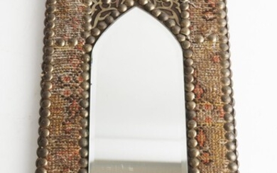 A MOGHUL TAPESTRY CLAD WOODEN WALL MIRROR WITH PROFUSE BRASS STUDDING AND A BEVELLED MIRROR PLATE 40 X 20CM, LEONARD JOEL LOCAL DELI...