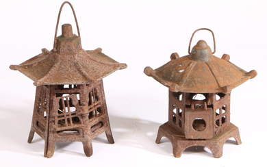 A NEAR PAIR OF EARLY TO MID 20TH CENTURY CAST IRON PAGODA CANDLE HOLDER LANTERNS.