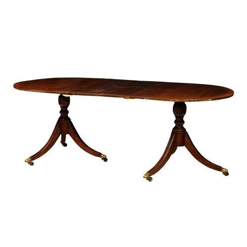 A Regency style cross banded mahogany double pedestal dining...