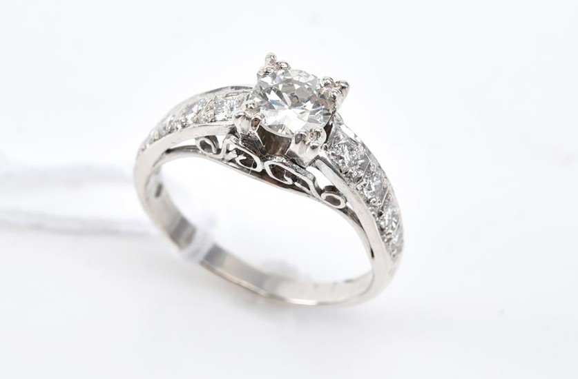 A TRANSITION CUT DIAMOND RING OF 0.60CTS/H/VS1 WITH DIAMOND SET SHOULDERS, SIZE M