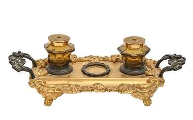 A Victorian gilt and patinated brass inkstand, cast with sat...