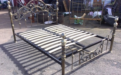 A Victorian style brushed brass double bed with arched scrolled...