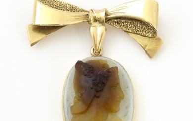 A cameo brooch, the oval cameo suspended from a 9ct gold bow...