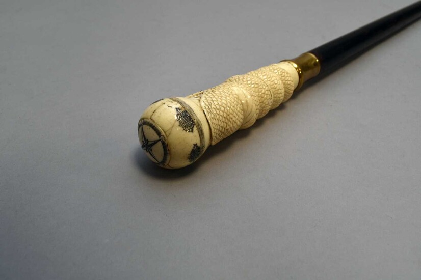 A carved bone-handled ebonised cane of nautical interest