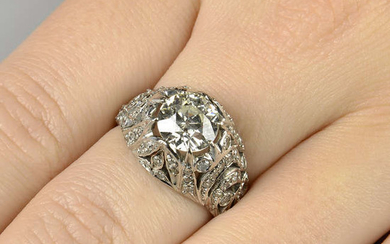 A circular-cut diamond single-stone ring, with single-cut diamond openwork foliate mount.