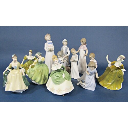 A collection of seven Nao figures of children including a ch...