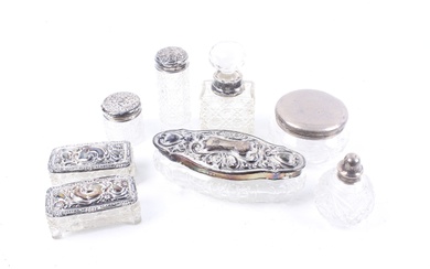 A collection of silver mounted clear cut glass dressing table jars, bottles, boxes and pots.