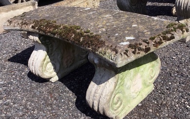 A crescent shaped composition stone garden seat with egg &...