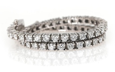 A diamond bracelet set with numeorus brilliant-cut diamonds weighing a total of...