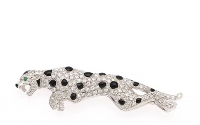 A diamond brooch in the shape of a panther set with numerous brilliant-cut diamonds, black enamel and a circular-cut emerald, mounted in 18k white gold.