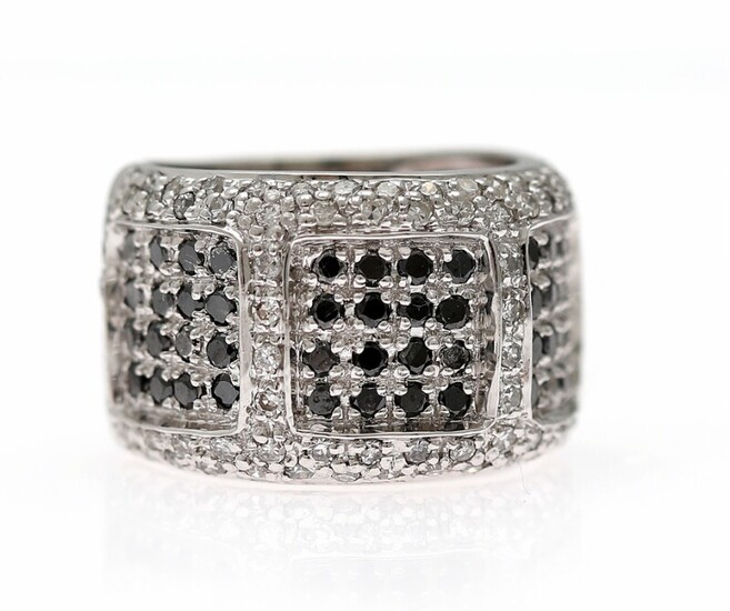 NOT SOLD. A diamond ring set with numerous black and white diamonds, mounted in 18k...