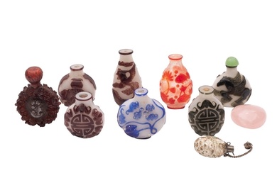 A group of seven Chinese overlay glass snuff bottles in blue...