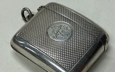 A large Victorian silver vesta case with engine turned decor...
