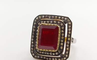 A large vintage style step-cut ruby and double diamond frame...