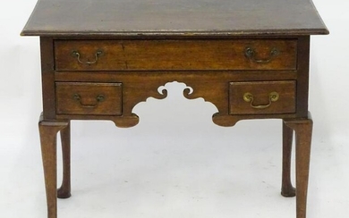 A mid 18thc oak lowboy with a moulded rectangular top