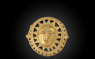 A modern West African gold sun circle pendant,...