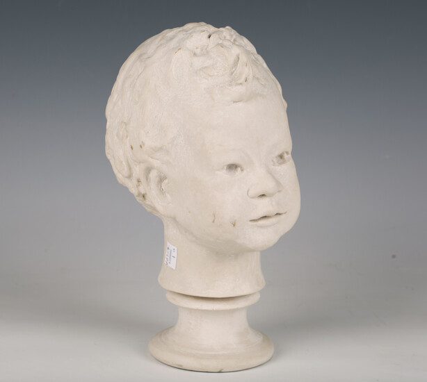 A modern reconstituted marble bust of a young boy, height 27cm.