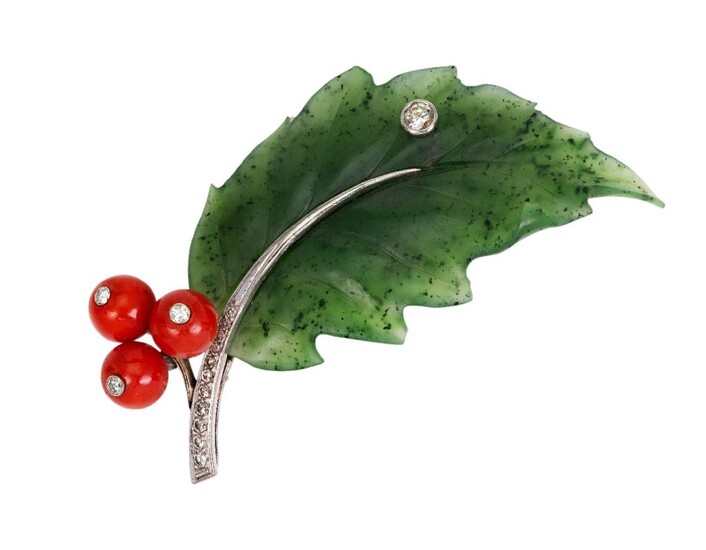 A nephrite coral and diamond brooch, designed as a single Holly leaf of carved nephrite to a brilliant- and single-cut diamond stem, accented with a single brilliant-cut diamond and three coral berries, indistinct marks to reverse, c.1960