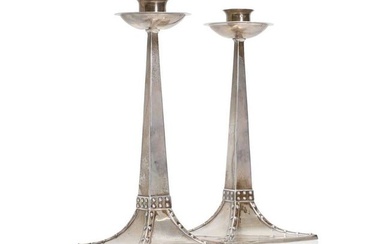 A pair of Arts and Crafts silver candlesticks