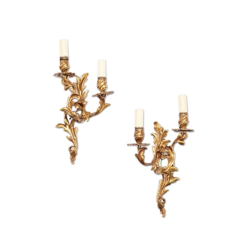 A pair of Louis XV style gilt bronze twin-light wall lights ...