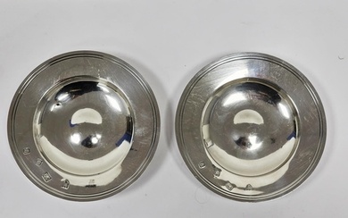 A pair of Queen Elizabeth II silver circular ashtrays/dishes...