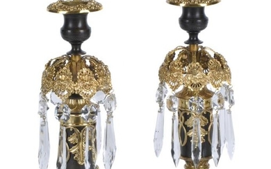 A pair of Regency parcel gilt and lacquered brass and cut glass lustre candlesticks