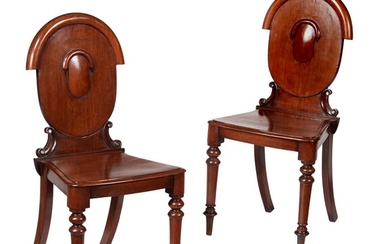 A pair of Victorian mahogany hall chairs