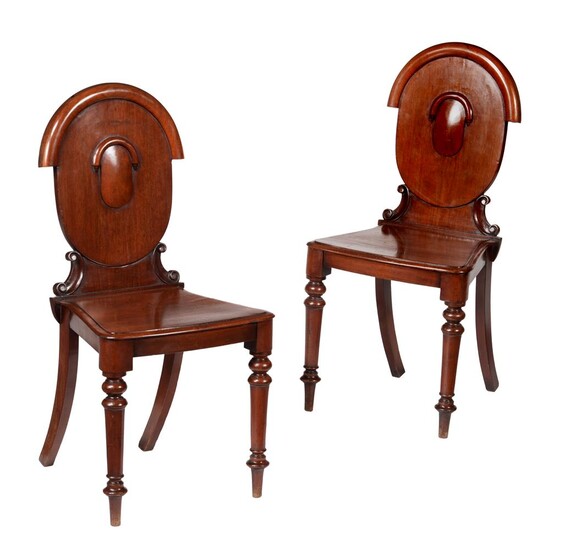 A pair of Victorian mahogany hall chairs