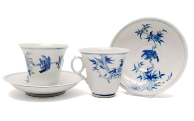 A pair of blue and white cups and saucers with underglaze copper red
