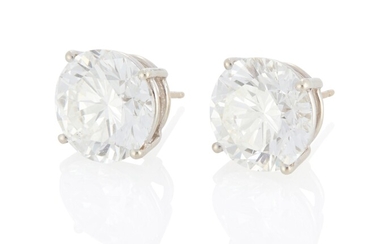 A pair of round diamond stud earrings