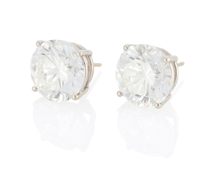 A pair of round diamond stud earrings