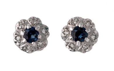A pair of sapphire and diamond earstuds, each designed as a circular cluster with single central circular-cut sapphire and single-cut diamond surround.