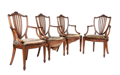 A set of four oak and upholstered armchairs in George III style