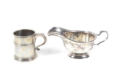 A silver christening mug and a sauce boat.
