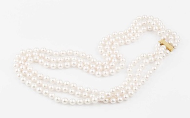 A triple strand uniform cultured pearl necklace, with 9ct gold...