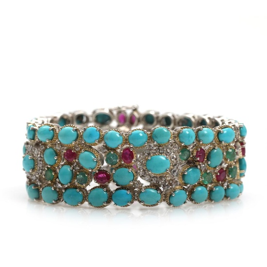 A turquoise, diamond, ruby and emerald bracelet set with numerous cabochon-cut turquoises,...