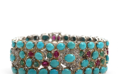 A turquoise, diamond, ruby and emerald bracelet set with numerous cabochon-cut turquoises,...