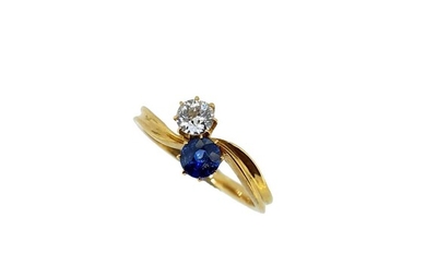 A two stone sapphire and diamond crossover style ring