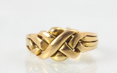 A yellow metal ‘puzzle’ ring, the stylised knot front compri...