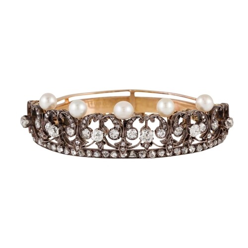 AN ANTIQUE PEARL AND DIAMOND BANGLE, of open worked design,...