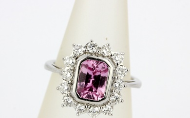An 18ct white gold ring set with pink sapphire, approx. 2ct, surrounded by brilliant cut diamonds, approx. 0.70ct total, (L.5). With EDR cer