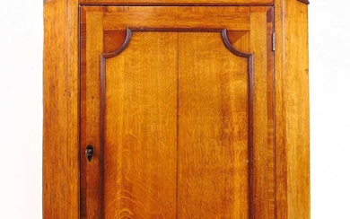 An 18th century oak and mahogany wall hanging corner cupboard,...