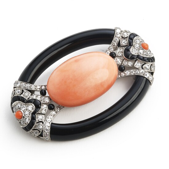 An Art Deco coral and diamond brooch set with carved coral, black onyx and old-cut diamonds, mounted in platinum. L. app. 6.8×4.5 cm. France, circa 1920–30.
