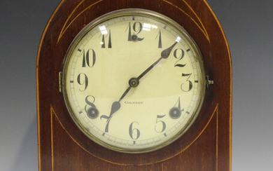 An Edwardian mahogany mantel clock with eight day movement striking on a gong, the circular dial wit