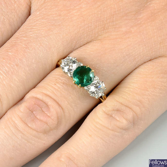 An early 20th century 18ct gold and platinum, Colombian emerald and old-cut diamond three-stone ring.