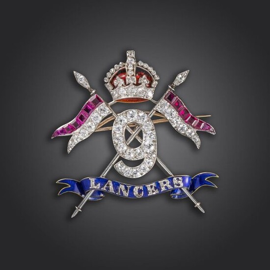 An impressive gem-set Regimental brooch for the 9th Lancers, set overall with circular-cut diamonds and square-cut rubies, further diamonds set to the ~lancers~, motto to the blue enamel ribbon, 4.5cm wide, case by Hancocks