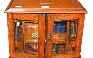 An oak smokers box with accessories including pipes