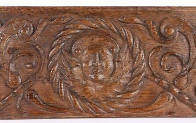 An unusual Henry VIII carved oak portrait panel, circa 1540, with capped face within a rope-twist