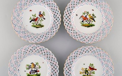 Four antique pierced Meissen plates with hand painted bird motifs. Mid 19th century.