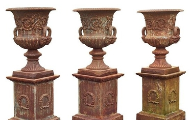 GROUP OF THREE CAST IRON GARDEN URNS AND PLINTHS 20TH